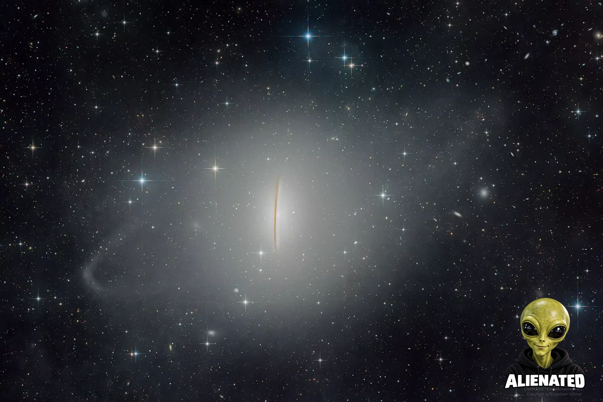 A starfield has an bright blobby mess in middle. Running vertically through the very middle is a dark streak. A diagonal ring of brightness surrounds the central blob.